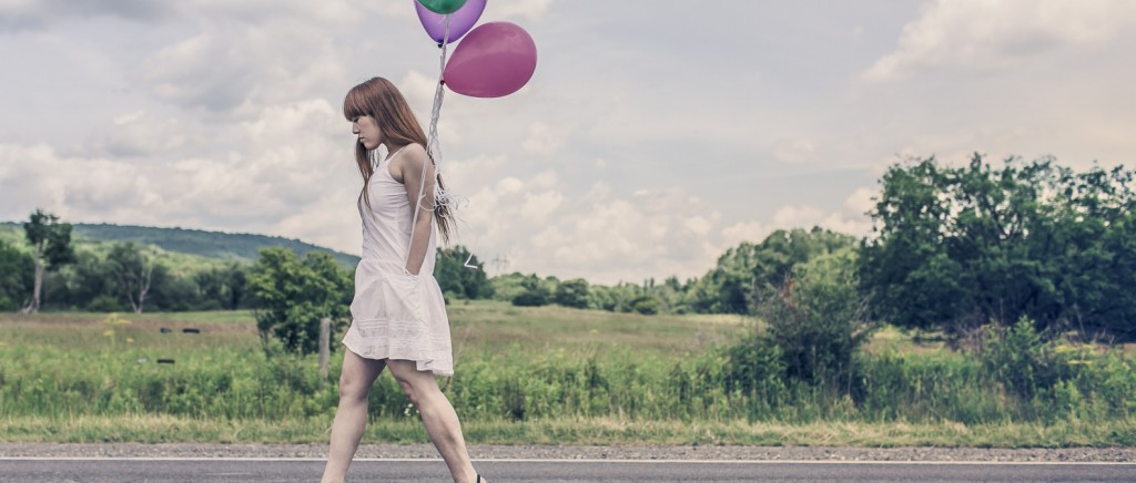 Picture of woman walking away with balloons