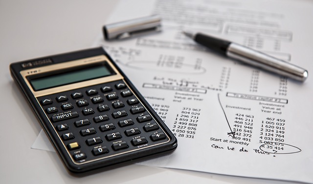 Finance sheet, pen and calculator