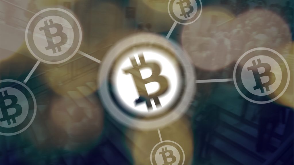 Bitcoin logos on backdrop