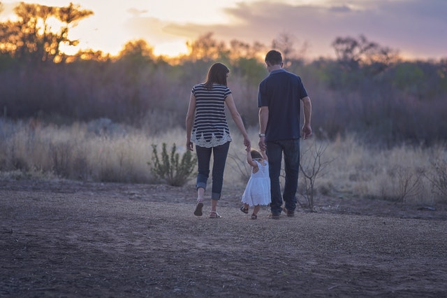 Young family taking a walk during sunset