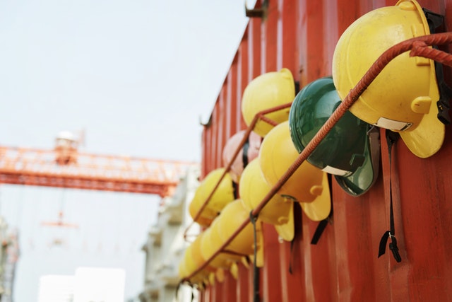 Workers' hard hats hung beside container