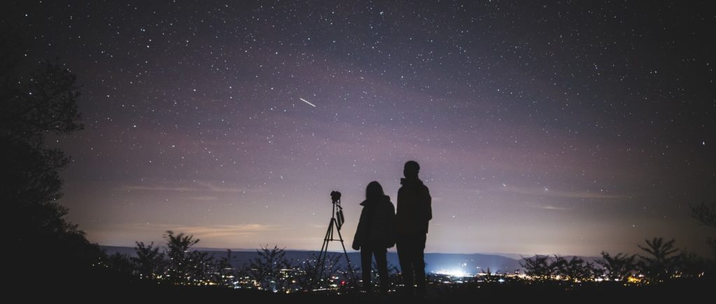 Couple starring into starry night