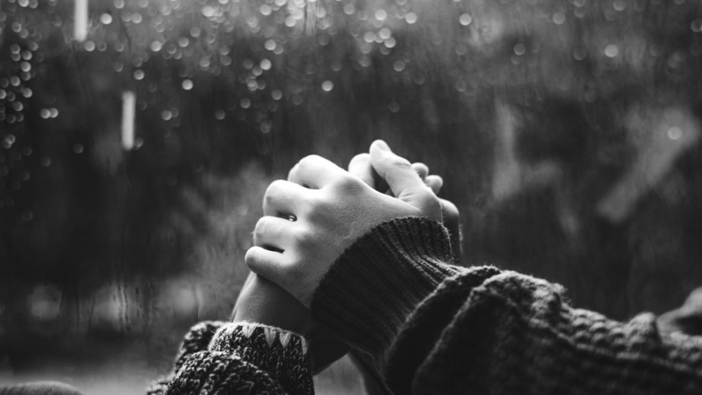 Holding hands in cafe during rain