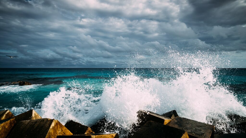 Waves crashing into rocks, signifying market crash